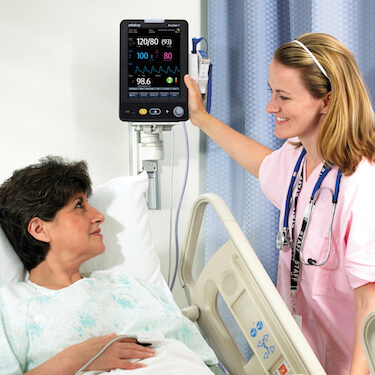 doctor reading vital signs monitor